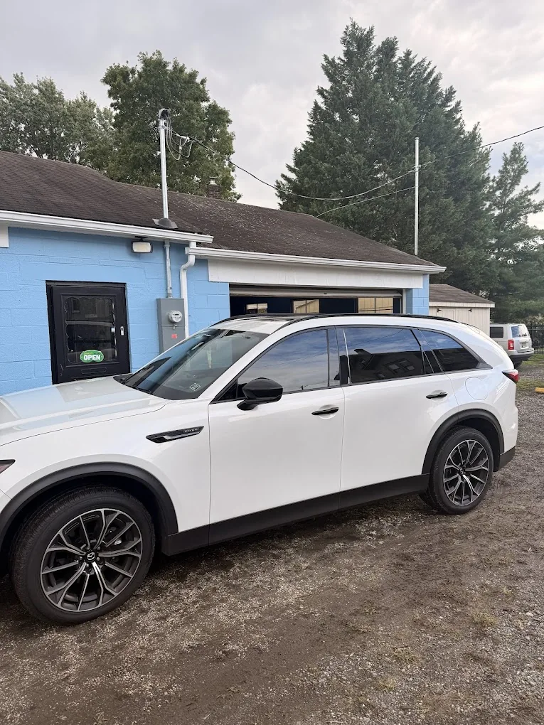 White SUV with dark tinted side windows at Premium Tints & Wraps